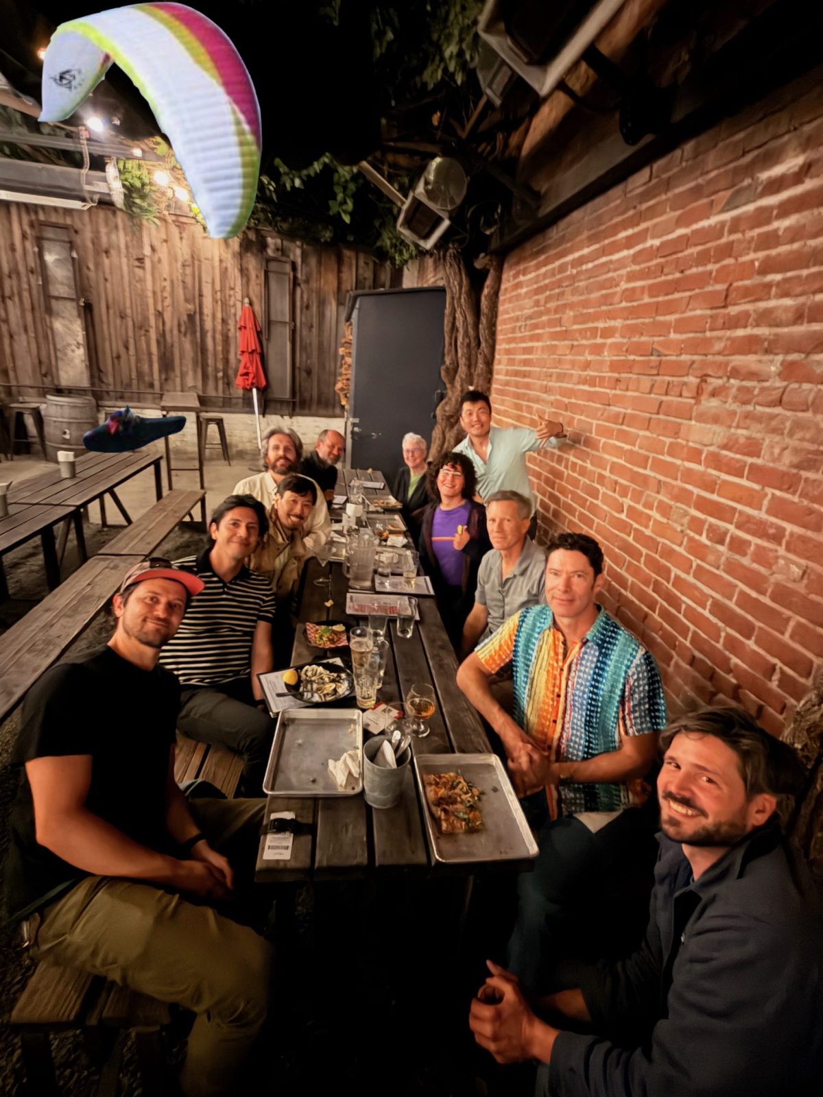 Wings of Rogallo members gathered around a picnic table for a club meetup.